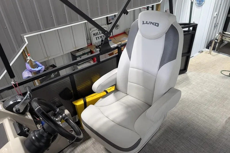 Slide: The Image of Captain's chair on 2018 Lund LX220 Pontoon boat, featuring sleek design and comfortable seating. - 16