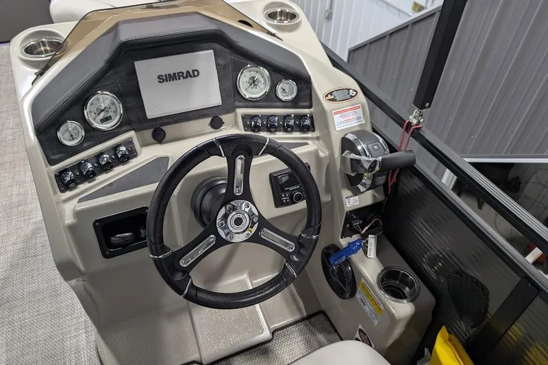 Slide: The Image of 2018 Lund LX220 Pontoon dashboard with steering wheel and Simrad display. - 17