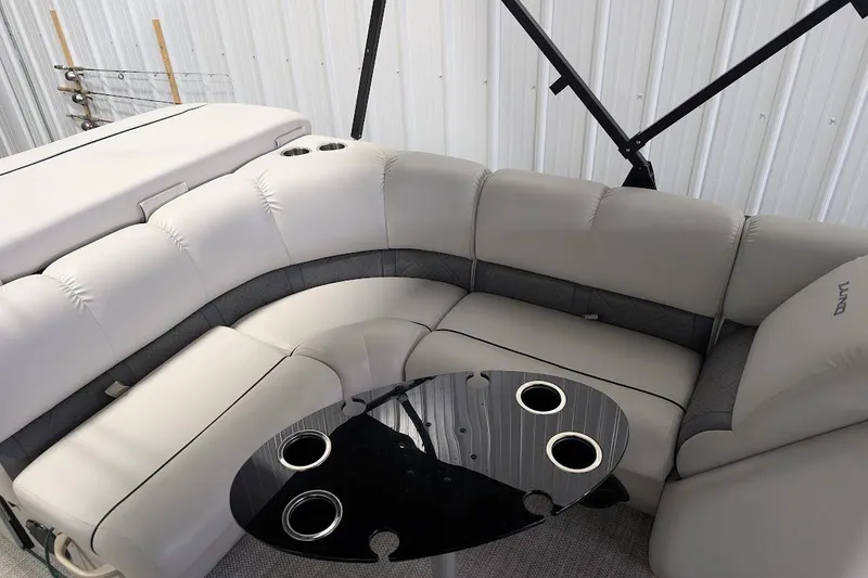 Slide: The Image of 2018 Lund LX220 Pontoon interior with plush seating and cup holders. - 21