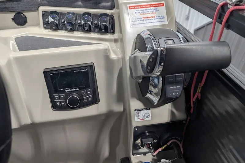 Slide: The Image of Control panel of a 2018 Lund LX220 Pontoon boat with throttle and audio system. - 32