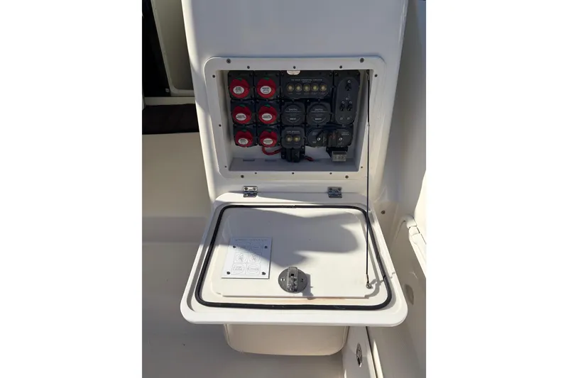 Slide: The Image of Electrical panel of a 2005 Pursuit 3370 Offshore boat, featuring switches and controls. - 11