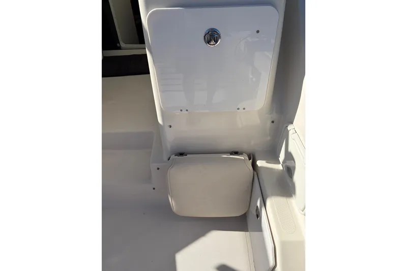 Slide: The Image of 2005 Pursuit 3370 Offshore boat interior with storage compartment and seating area. - 12