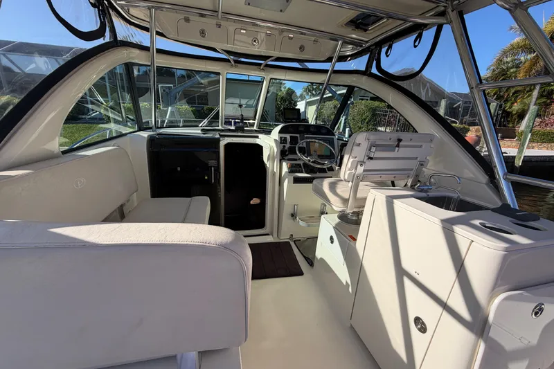 Slide: The Image of Interior view of a 2005 Pursuit 3370 Offshore boat, featuring seating and helm area. - 15
