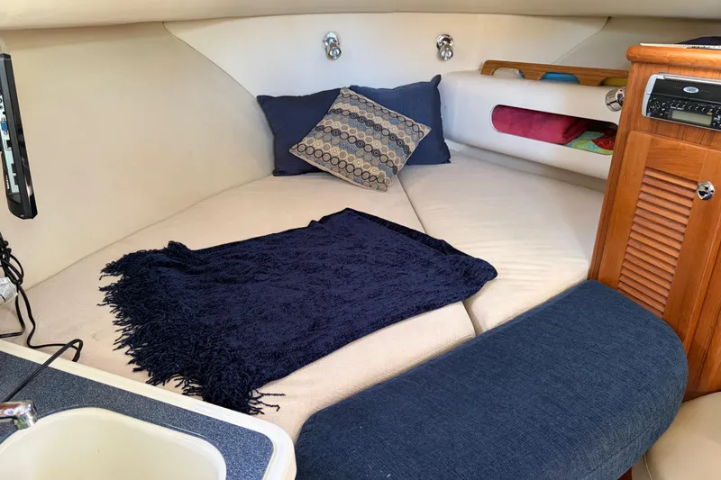 Slide: The Image of Cozy cabin interior of 2005 Pursuit 3370 Offshore boat with cushions and pillows. - 16