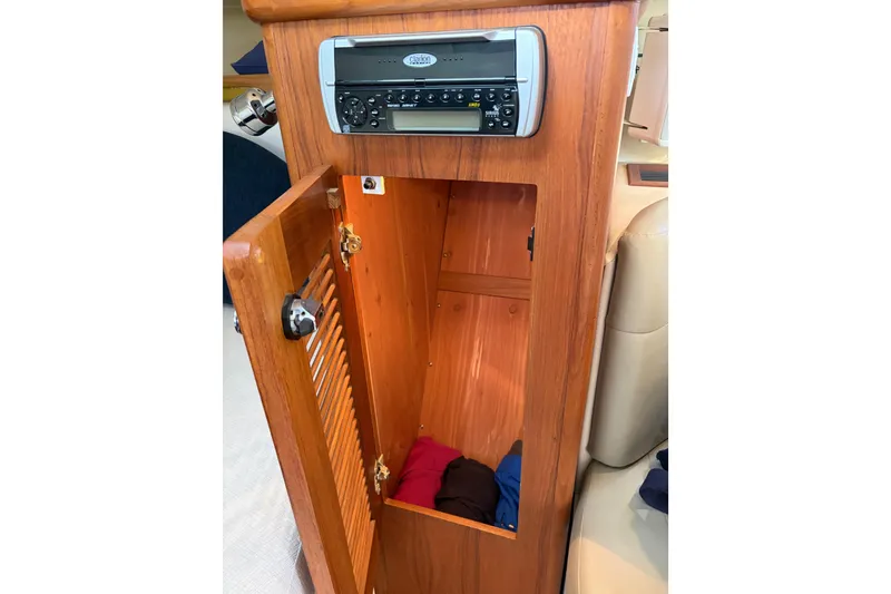 Slide: The Image of 2005 Pursuit 3370 Offshore cabin with wooden storage and stereo system. - 17