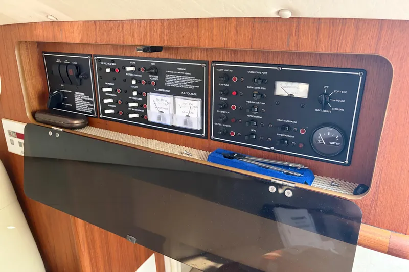 Slide: The Image of Control panel of a 2005 Pursuit 3370 Offshore boat with various switches and gauges. - 20
