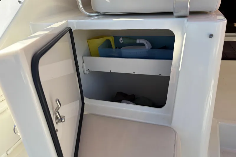 Slide: The Image of Open storage compartment on 2005 Pursuit 3370 Offshore boat, showing interior contents. - 5