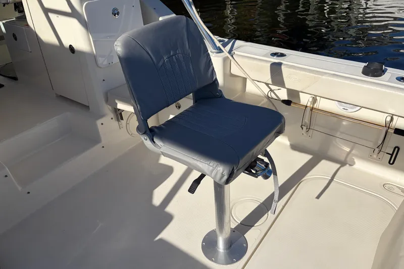 Slide: The Image of Captain's chair on 2005 Pursuit 3370 Offshore boat deck, near water. - 6