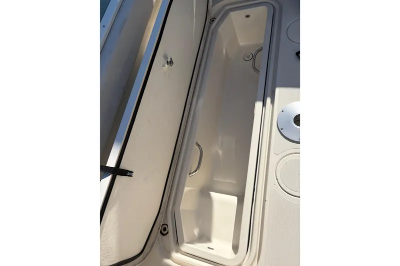 Slide: The Image of Open storage compartment on a 2005 Pursuit 3370 Offshore boat deck. - 9