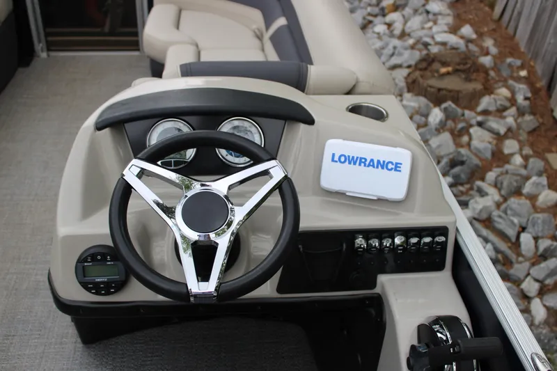 Slide: The Image of 2022 Baretta Cabrio C22CC boat dashboard with steering wheel and Lowrance navigation system. - 21