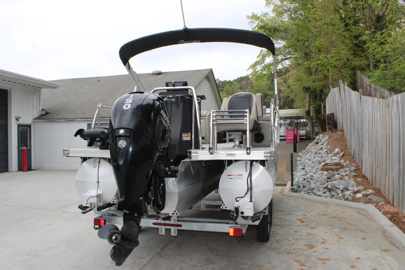 Slide: The Image of 2022 Baretta Cabrio C22CC boat with powerful outboard motor in a driveway setting. - 3