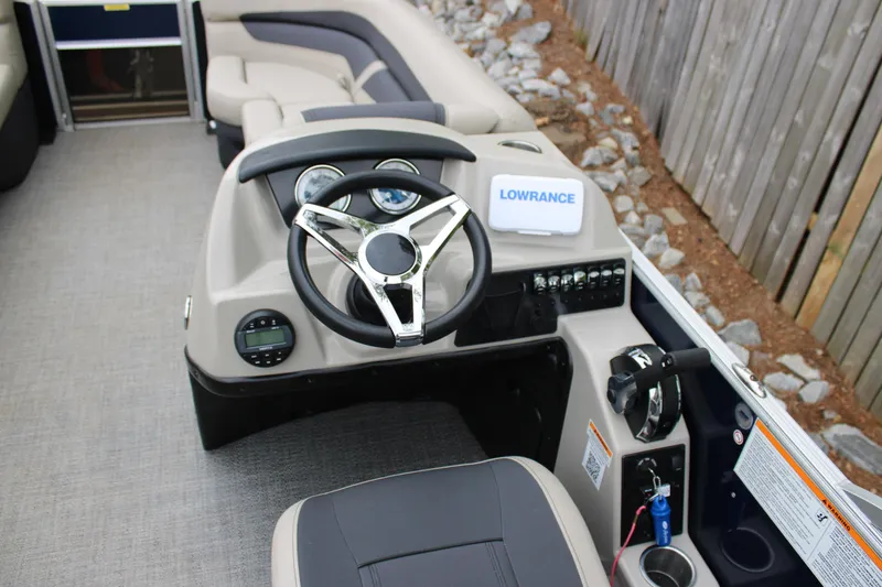 Slide: The Image of 2022 Baretta Cabrio C22CC boat dashboard with steering wheel and Lowrance device. - 6