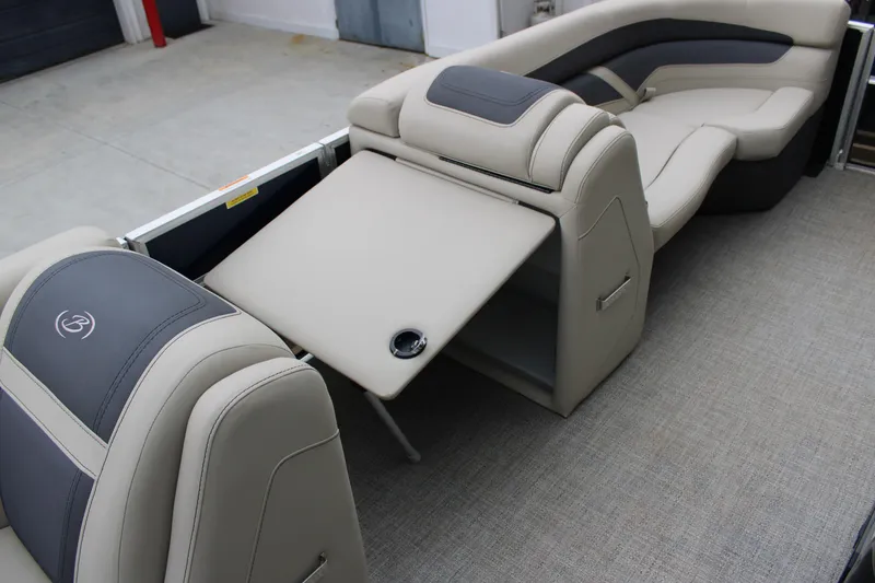 Slide: The Image of 2022 Baretta Cabrio C22CC boat interior with luxurious seating and foldable table. - 7