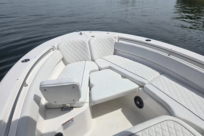 Slide: The Image of 2024 Sea Fox 248 Side Console boat on calm water, showcasing sleek design. - 4