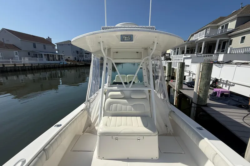 Slide: The Image of 2009 Regulator 26 Forward Seating boat docked near waterfront homes. - 10