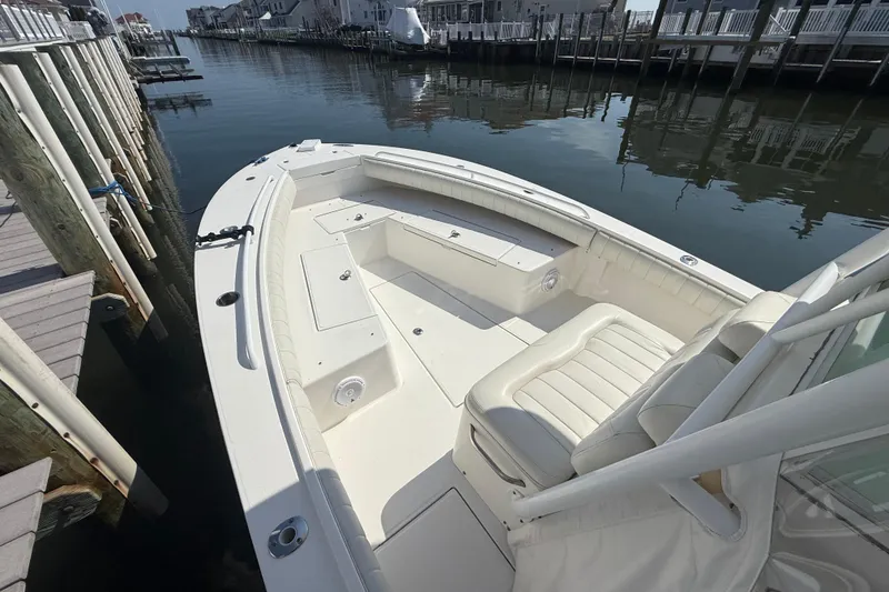 Slide: The Image of 2009 Regulator 26 Forward Seating boat docked by waterfront homes. - 14