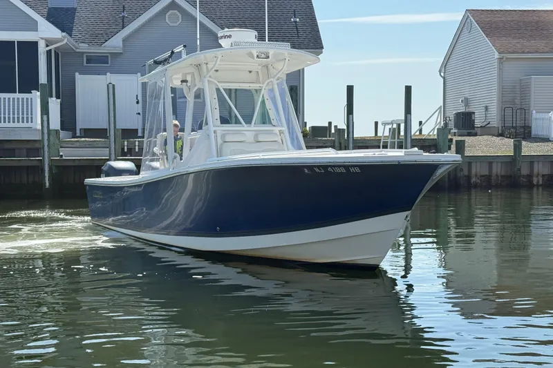 Slide: The Image of 2009 Regulator 26 Forward Seating boat docked near waterfront homes. - 9