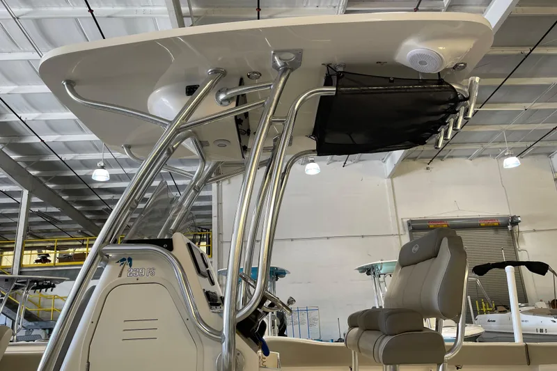 Slide: The Image of 2024 Key West 239 FS boat interior with T-top and seating in a showroom. - 10