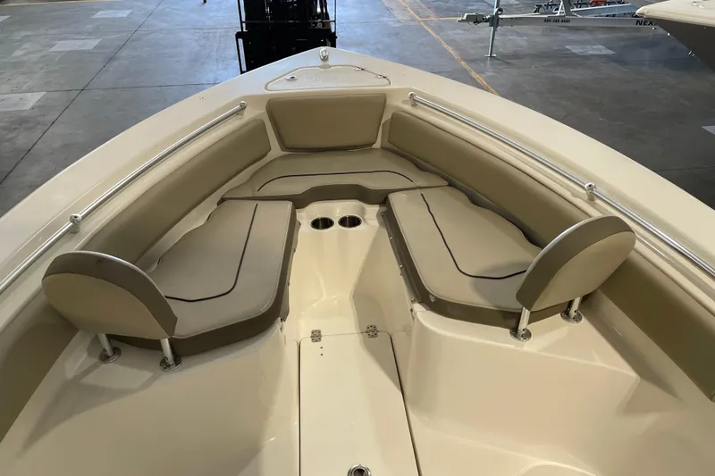 Slide: The Image of 2024 Key West 239 FS boat interior with cushioned seating and cup holders. - 11