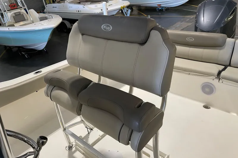 Slide: The Image of 2024 Key West 239 FS boat interior with cushioned seating and steering wheel. - 17