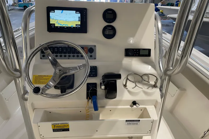 Slide: The Image of 2024 Key West 239 FS boat dashboard with steering wheel and navigation display. - 18