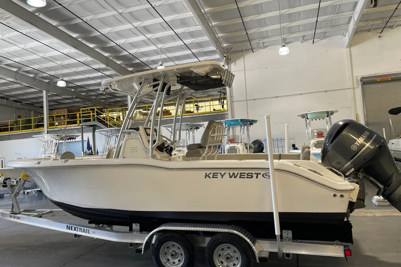 Slide: The Image of 2024 Key West 239 FS boat on trailer in warehouse setting. - 2