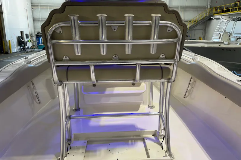 Slide: The Image of 2024 Key West 239 FS boat interior with rod holders and seating in a showroom. - 21