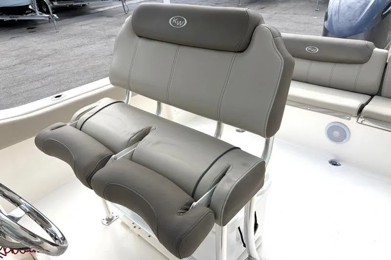 Slide: The Image of 2024 Key West 239 FS boat interior with cushioned seating and steering wheel. - 26