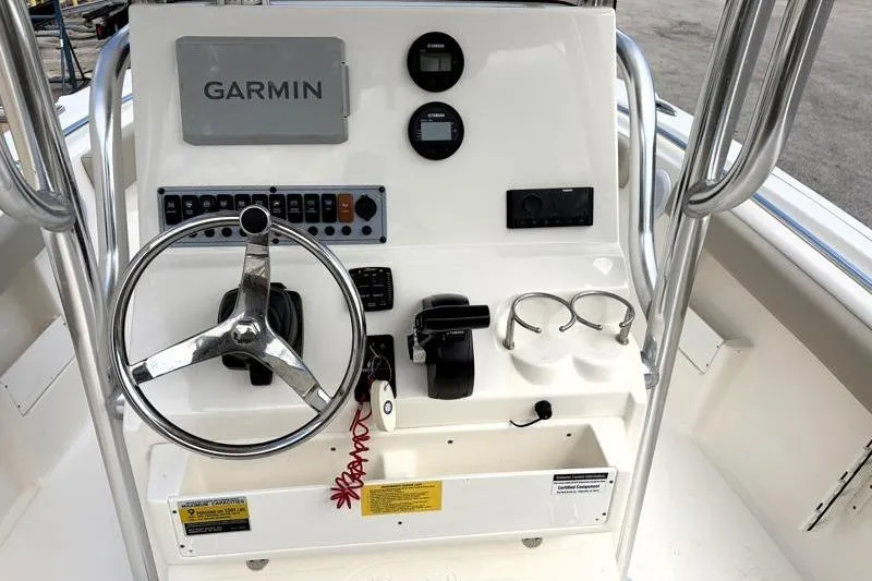 Slide: The Image of 2024 Key West 239 FS boat console with Garmin navigation, steering wheel, and control panel. - 27