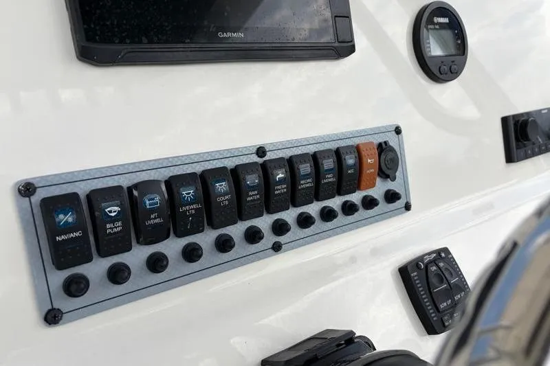 Slide: The Image of Control panel of 2024 Key West 239 FS boat with various switches and displays. - 29