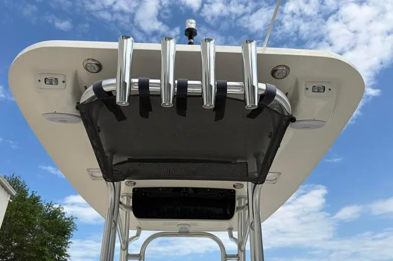Slide: The Image of 2024 Key West 239 FS boat T-top with rod holders against blue sky. - 36