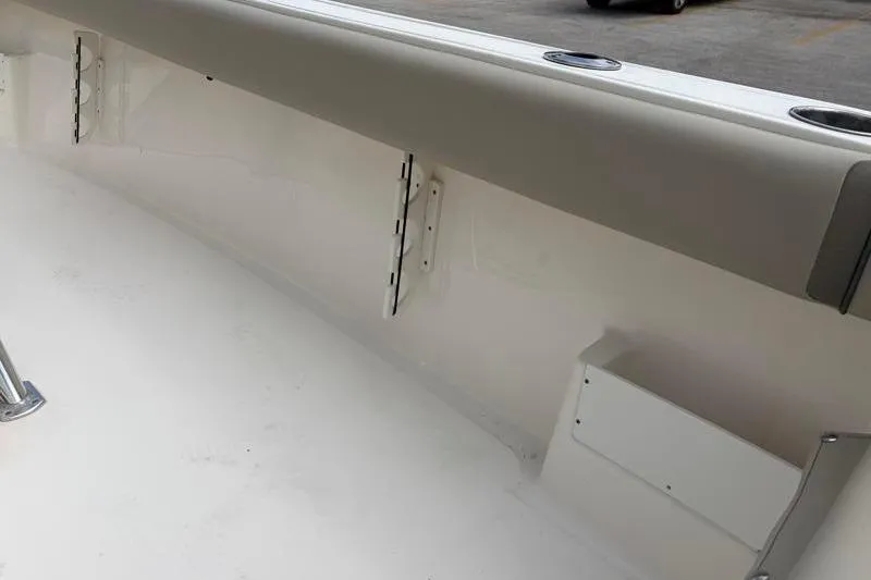 Slide: The Image of 2024 Key West 239 FS boat interior detail with rod holders and cushioned side panel. - 37