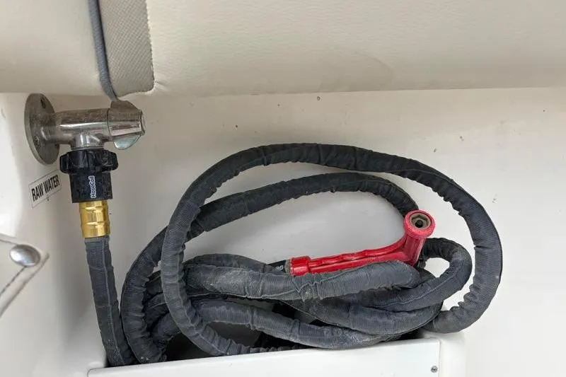 Slide: The Image of Coiled hose and raw water outlet on 2024 Key West 239 FS boat. - 39