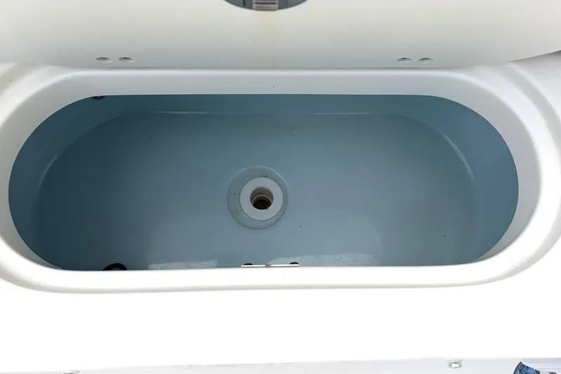 Slide: The Image of Livewell compartment of 2024 Key West 239 FS boat, featuring a clean, oval design. - 40