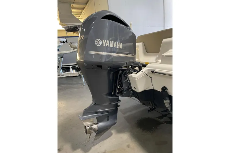 Slide: The Image of 2024 Key West 239 FS boat with Yamaha outboard motor in a showroom. - 7