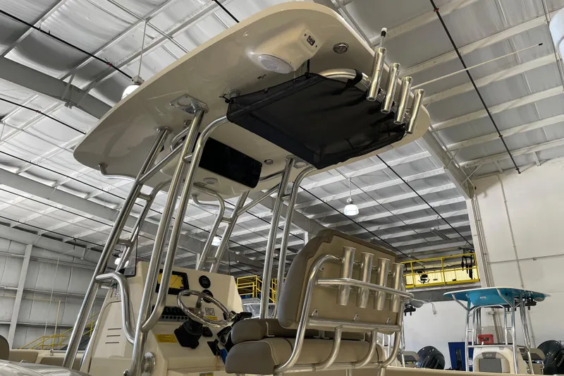 Slide: The Image of 2024 Key West 239 FS boat interior with T-top and rod holders in a warehouse setting. - 9