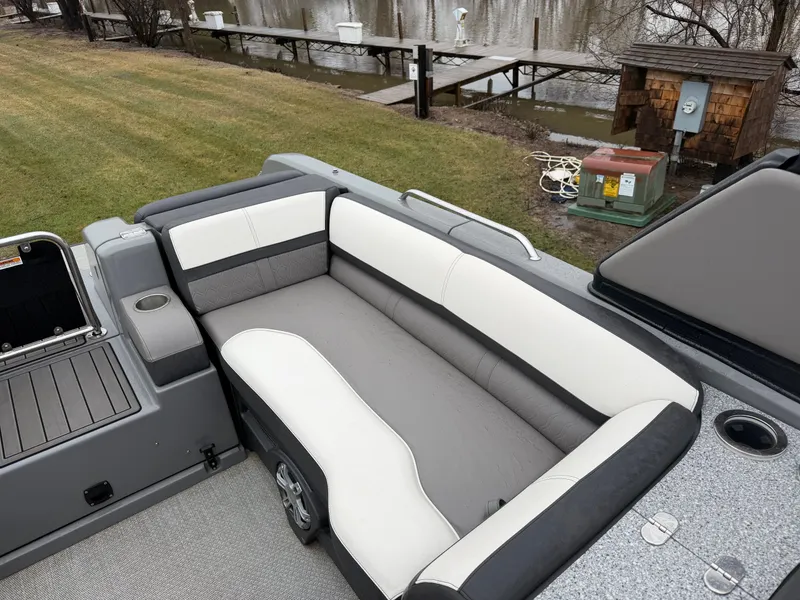 Slide: The Image of 2023 Tahoe WAKETOON boat with gray and white seating area by the lake. - 5