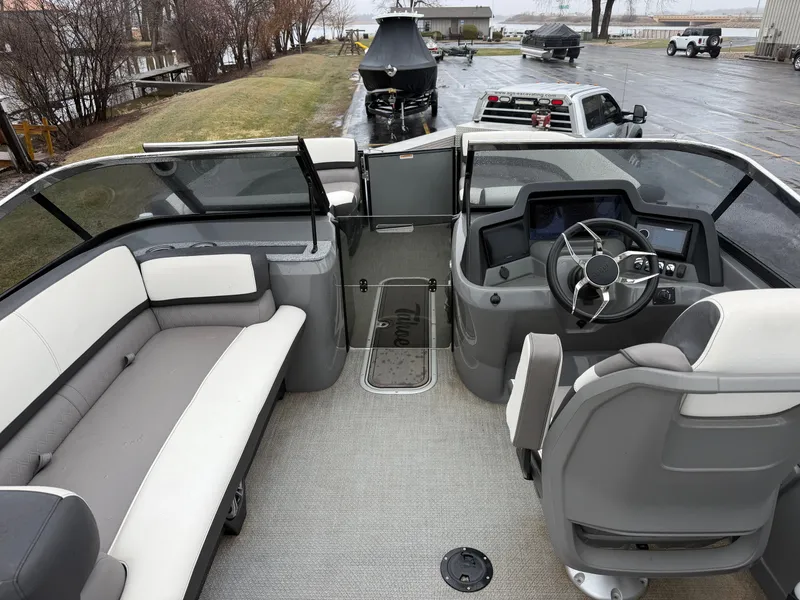 Slide: The Image of Interior of a 2023 Tahoe WAKETOON boat with steering wheel and seating area. - 6