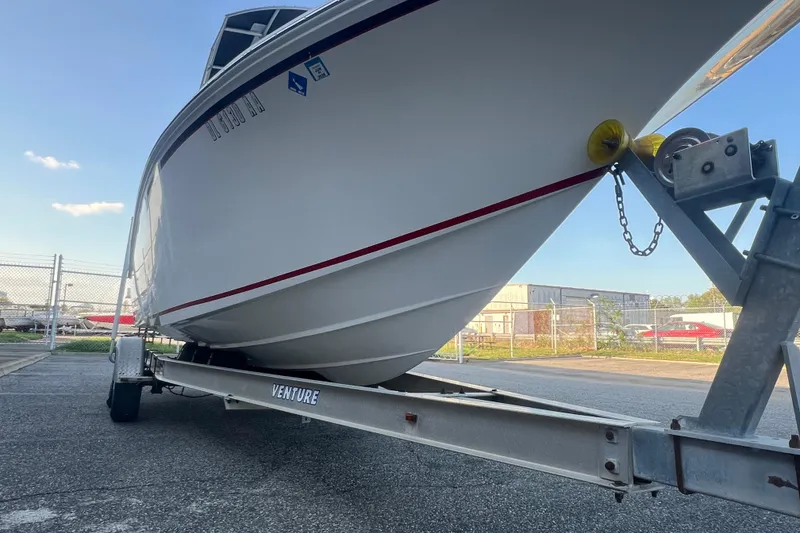 Slide: The Image of 2006 Fountain 23 Center Console boat on trailer in industrial area. - 12