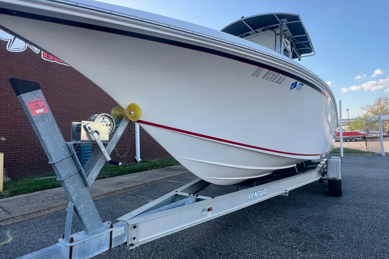 Slide: The Image of 2006 Fountain 23 Center Console boat on trailer, parked outdoors. - 14