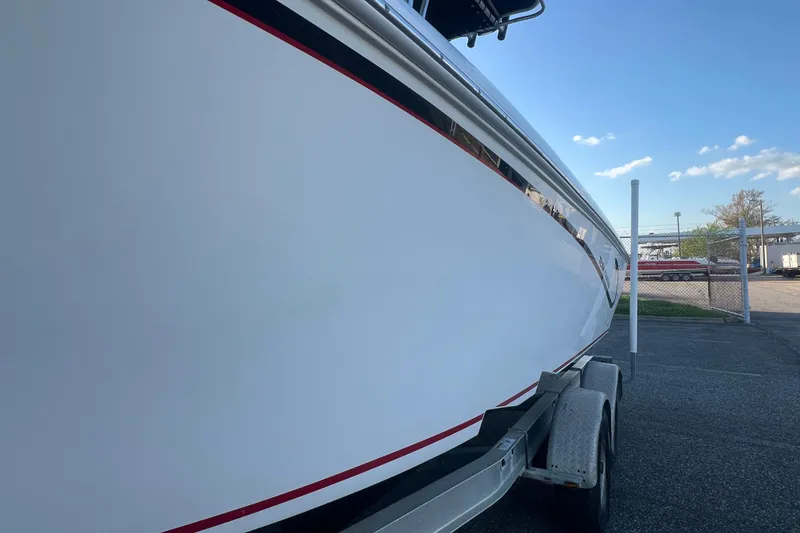Slide: The Image of 2006 Fountain 23 Center Console boat on trailer, side view under clear sky. - 15