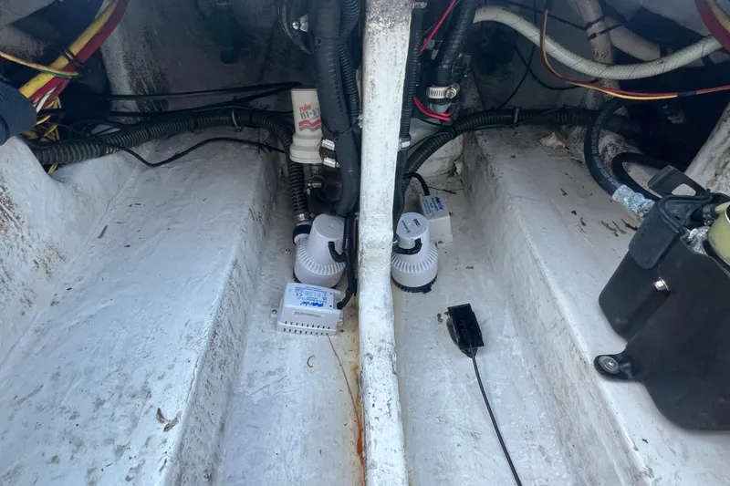 Slide: The Image of Bilge area of a 2006 Fountain 23 Center Console boat with wiring and pumps. - 19