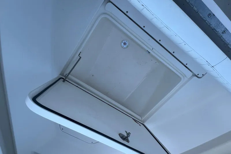 Slide: The Image of Open storage compartment on a 2006 Fountain 23 Center Console boat. - 23