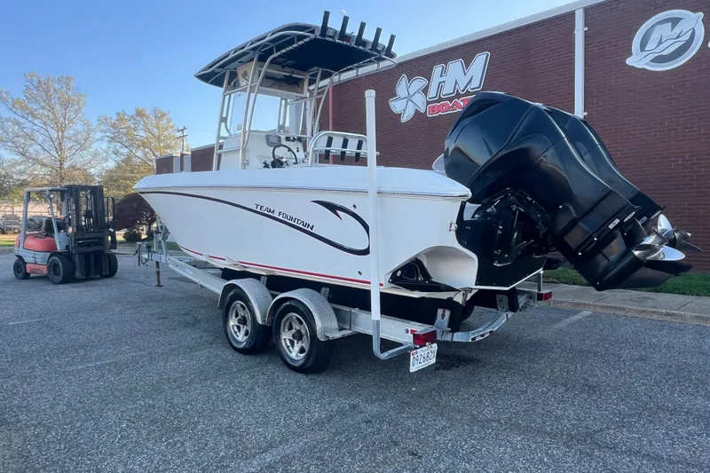 Slide: The Image of 2006 Fountain 23 Center Console boat on trailer, parked outside a building. - 3