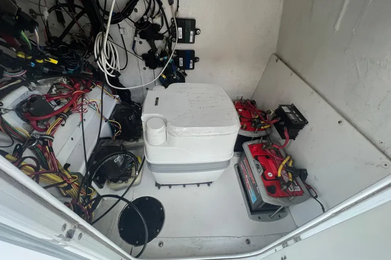 Slide: The Image of Interior of a 2006 Fountain 23 Center Console boat showing wiring and batteries. - 35
