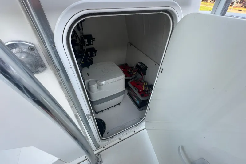 Slide: The Image of Interior of a 2006 Fountain 23 Center Console boat showing storage compartment with batteries. - 36