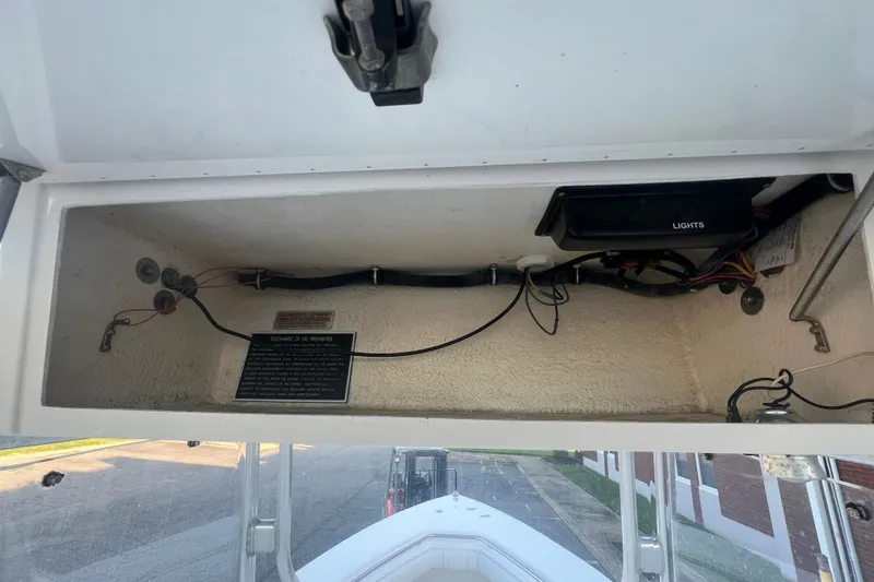 Slide: The Image of Electrical compartment of a 2006 Fountain 23 Center Console boat, showing wiring and components. - 39