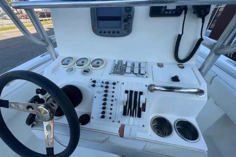 Slide: The Image of 2006 Fountain 23 Center Console boat dashboard with steering wheel and control panel. - 40