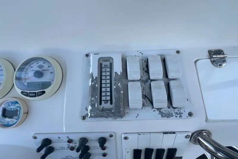 Slide: The Image of Control panel of a 2006 Fountain 23 Center Console boat with gauges and switches. - 41