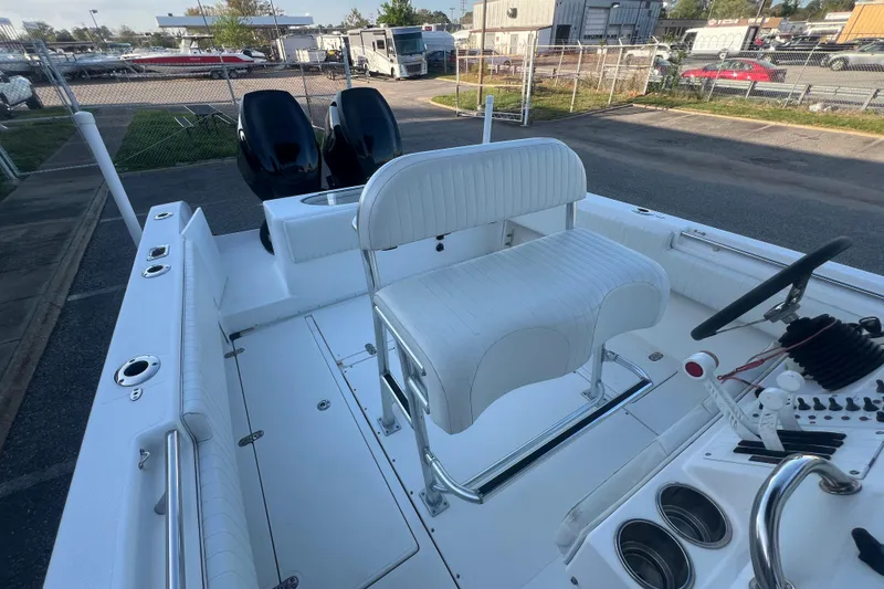 Slide: The Image of 2006 Fountain 23 Center Console boat interior with dual engines and white seating. - 46